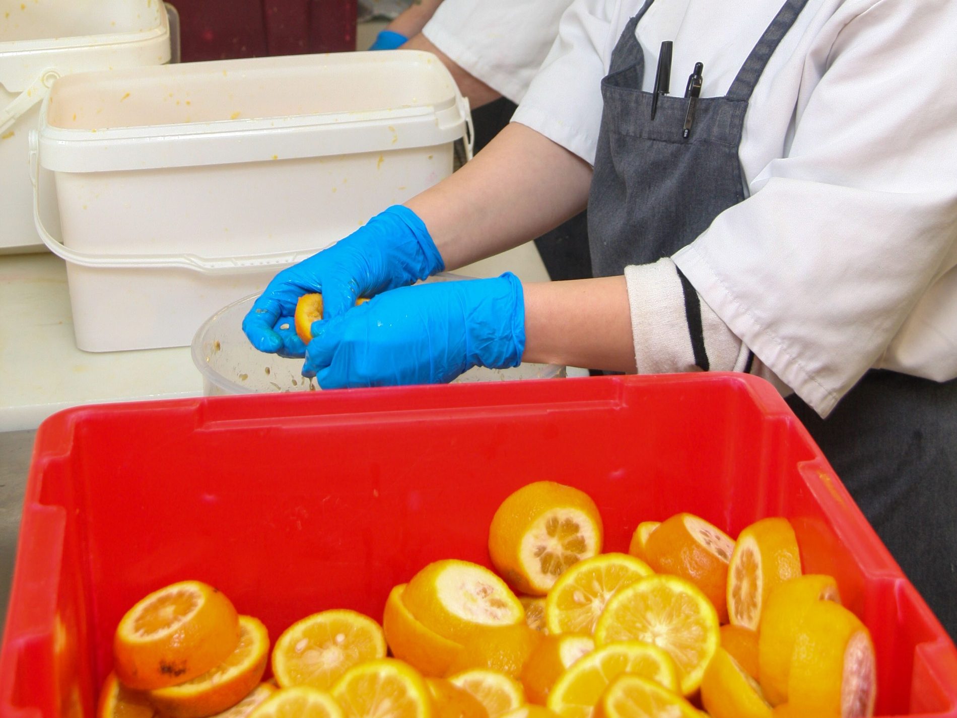 Juicing oranges by hand for marmalade at McNeill's Fine Foods